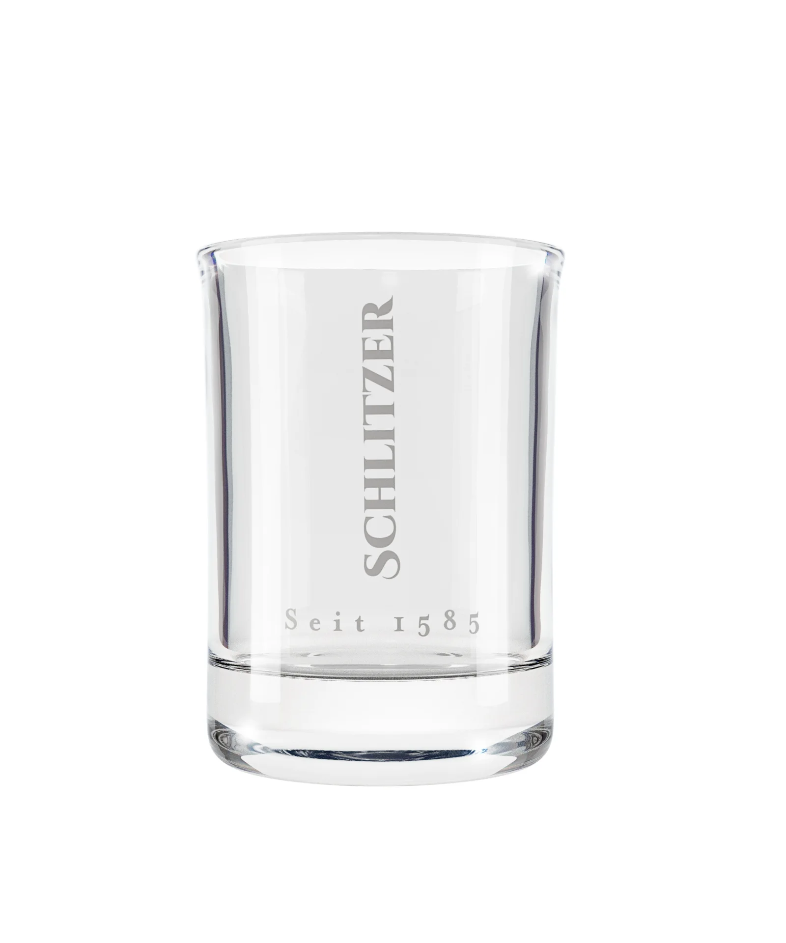 Stamper Shotglas aus Glas mit graviertem Schlitzer Destillerie Logo – Spirituosen Glas für Schnaps und Liköre Stamper Shot Glas aus Klarglas mit Schlitzer Destillerie Logo, stehend auf weißem Hintergrund – hochwertiges Schnapsglas für Spirituosenliebhaber.